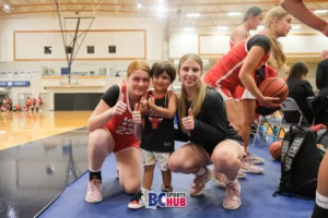 VK Basketball's Olivia Wheatley and Isabella Heffring pose with a young fan.