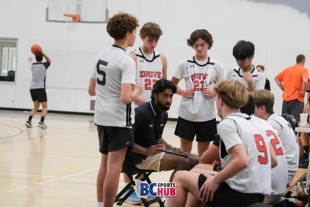 Drive Basketball huddles together during a time out.