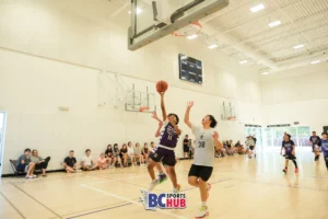 Fundamentals Basketball's #11 jumps up for a layup while loosely guarded.